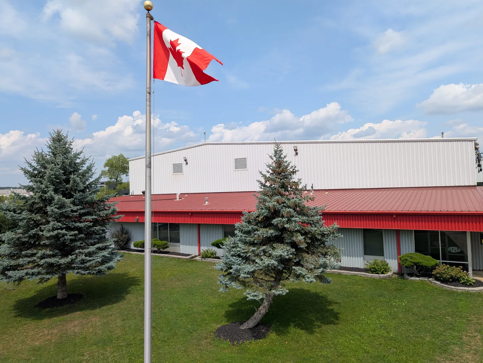 Ultramet Industries in Breslau, Ontario — facility exterior with the Canadian flag flying out front.